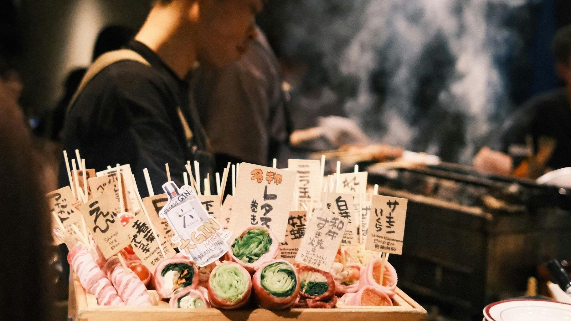 Experience the vibrant ambiance of a Japanese yakitori bar with skewer dishes prepared by skilled chefs.