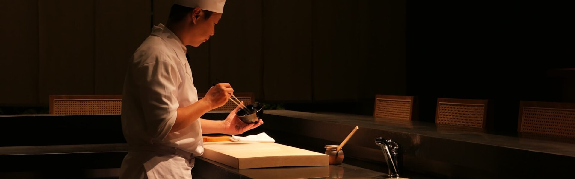 a man standing in a kitchen next to a sink
